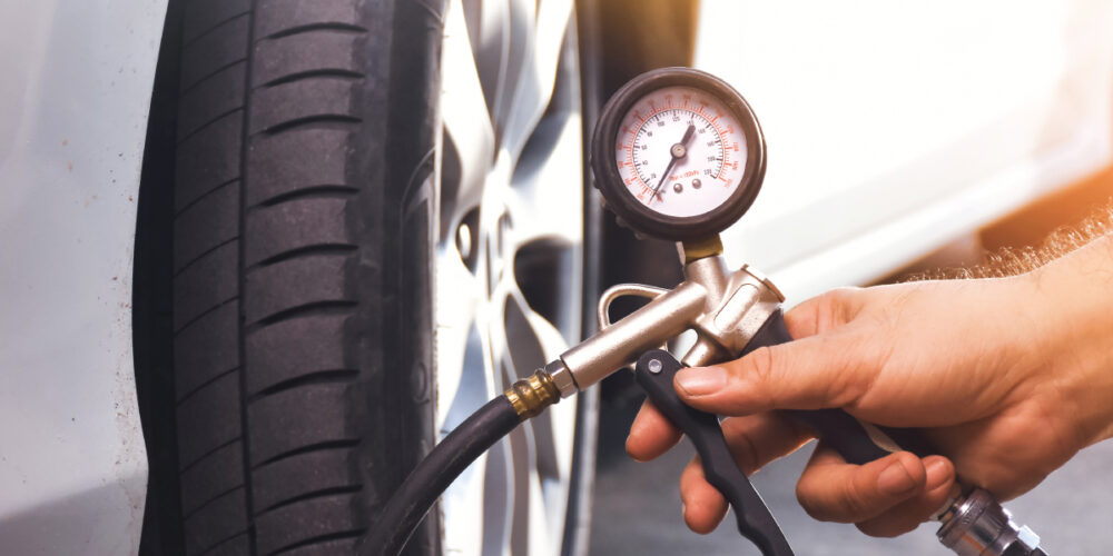 driver checking tire pressure