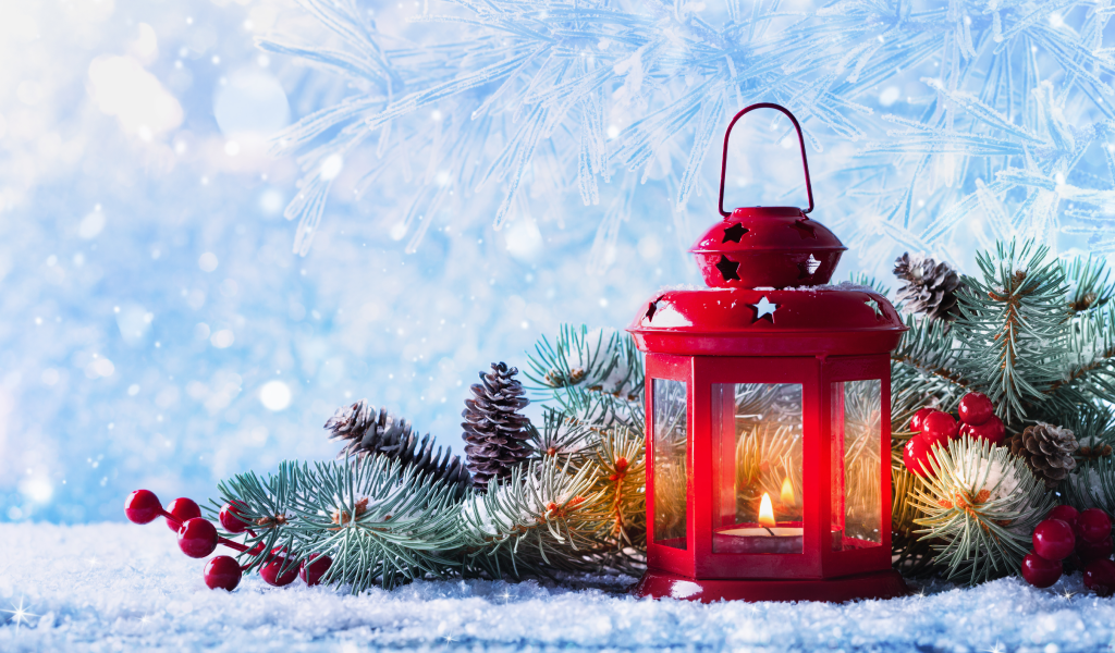holiday candle with decorations and blue, snowy background