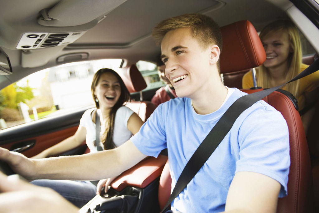 Smiling teenagers in a car