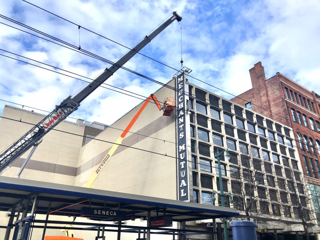 workers with sign crane