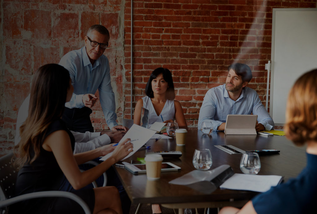 Insurance professionals at conference table