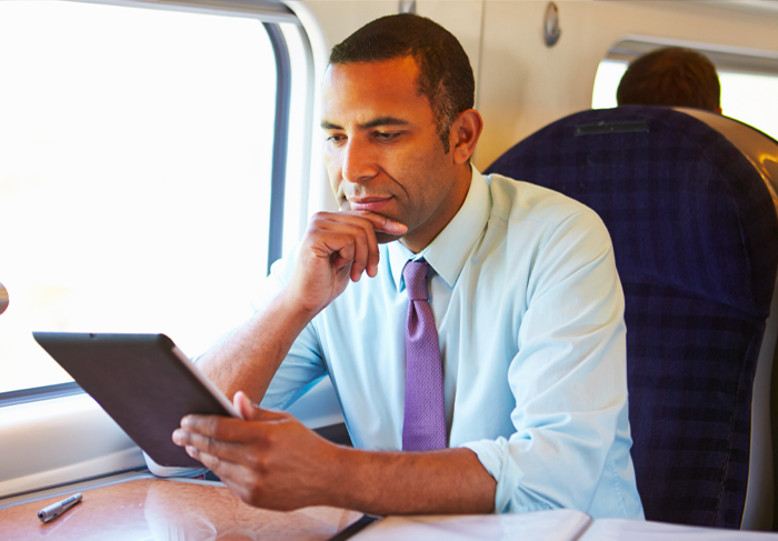 Man using ipad on airplane