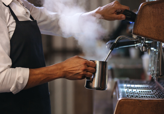 Cafe barista making espresso