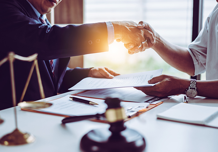 Lawyer shaking hands with client