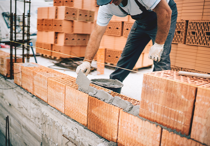 mason laying bricks