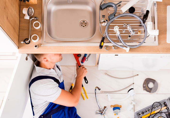 Plumber working on kitchen sink