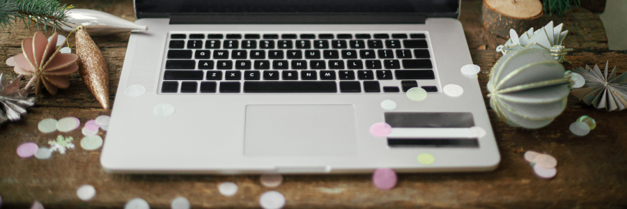 Laptop with Christmas decorations on keyboard for holiday shopping season and Cyber Monday