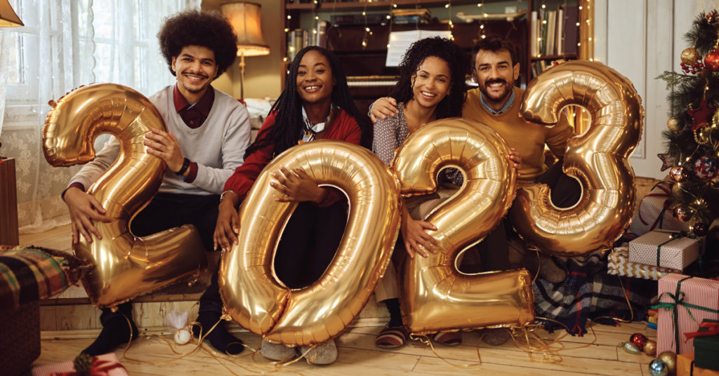 friends inside home celebrating holidays, following new year's eve safety tips
