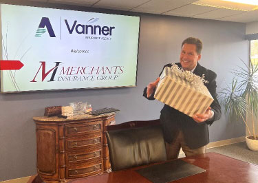 Vanner Insurance Agency's RJ Vanner with Agent of the Year award gift