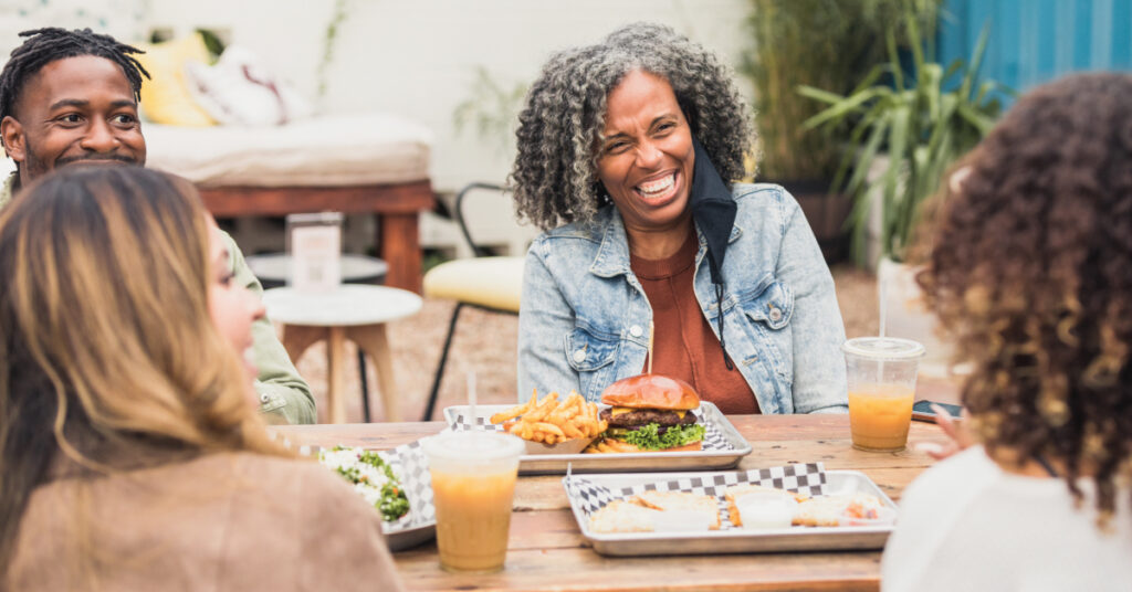 happy people enjoy meal on restaurant patio