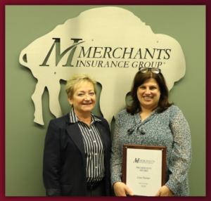 Merchants' Christine Schmitt and Lisa Turner pose with President's Award plaque