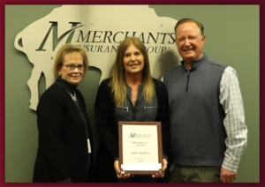 Kelly Julius, Kathy Rambuss, and Charles Makey with Merchants' President's Award plaque