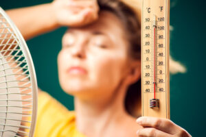 Woman holds thermometer during a heat wave