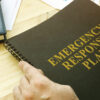 notebook labeled "emergency response plan" in anticipation for hurricane season
