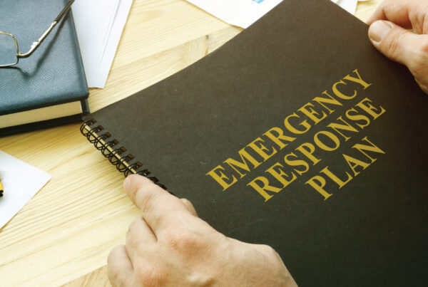 notebook labeled "emergency response plan" in anticipation for hurricane season