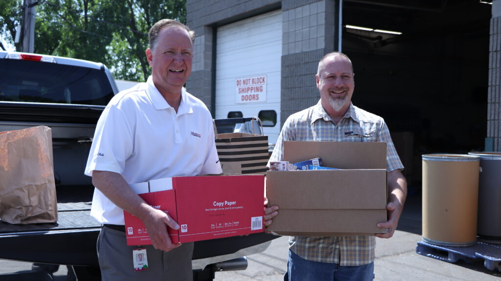 Merchants' Charles Makey and Matt Sedita carry donations into FeedMore WNY warehouse