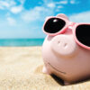 piggy bank on the beach in summer; boosting business