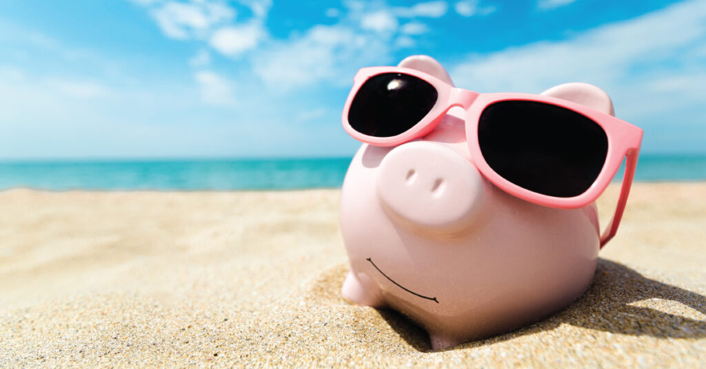 piggy bank on the beach in summer; boosting business