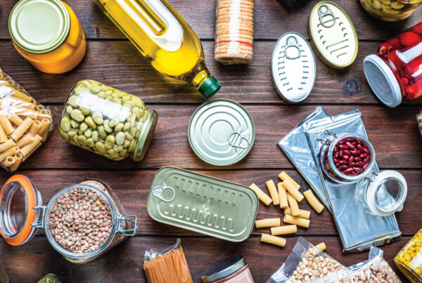 Non-perishable food background: overhead view of canned goods, conserves, sauces, and oils