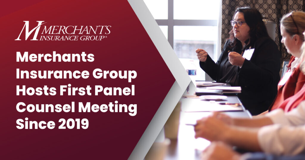 Text reads "Merchants Insurance Group hosts first panel counsel meeting since 2019" over photo of attendees sitting at table, having conversation