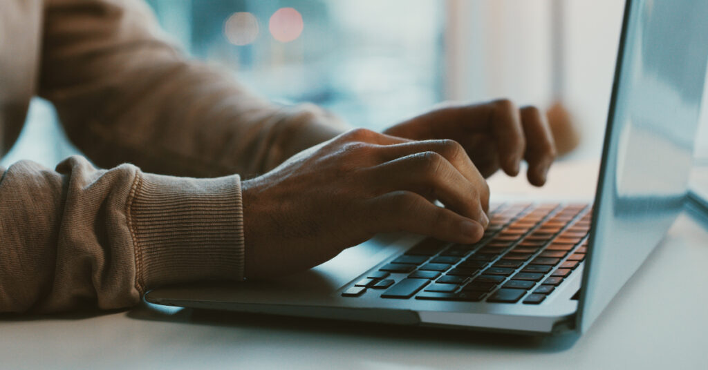 hands typing on keyboard