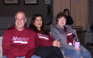 colleagues sit together at Merchants' 105th anniversary celebration