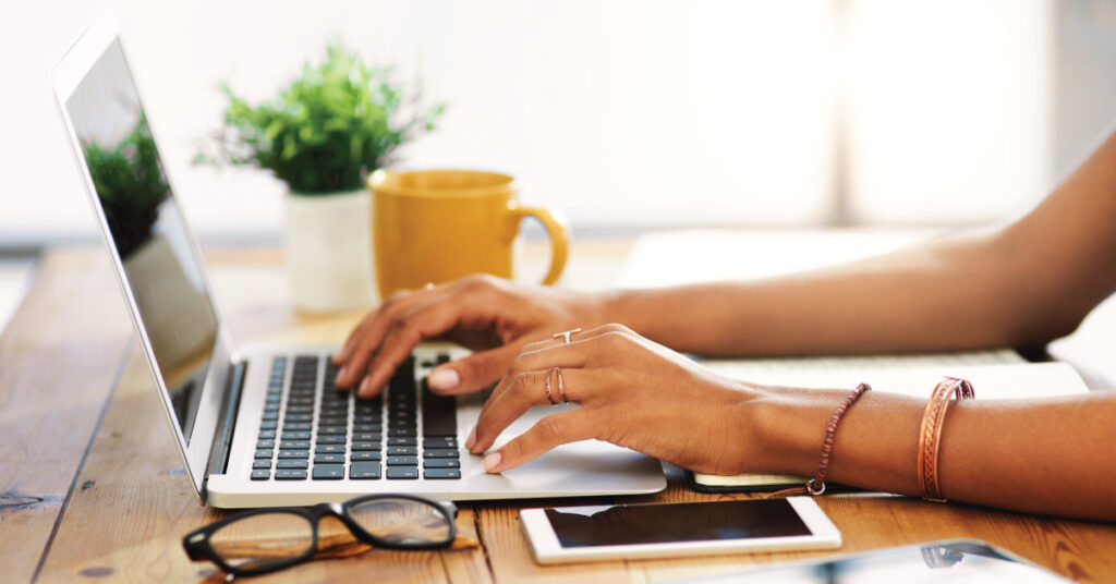 person typing a blog on a computer