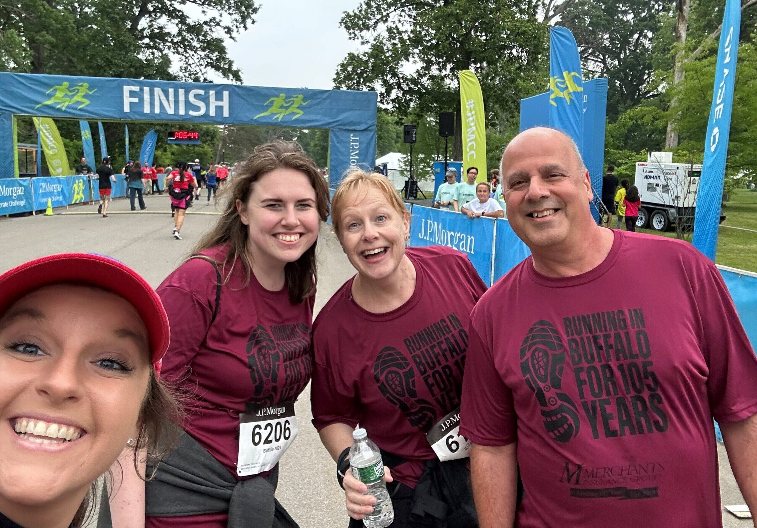 Erica Dalton, Katherine Trautwein, Laurie Maniccia, and Rob Ader smile at the finish line, completing the Corporate Challenge!