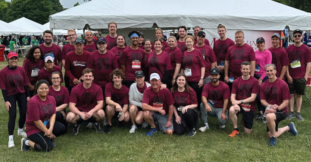 Corporate Challenge 2023 team photo at Merchants company tent