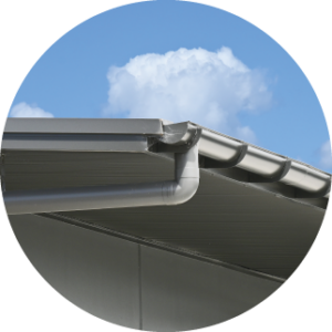 image of gutter on a roof with blue sky in the background