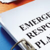 binder with "Emergency Response Plan" on desk, binder contains in-case-of-emergency plan