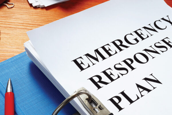 binder with "Emergency Response Plan" on desk, binder contains in-case-of-emergency plan