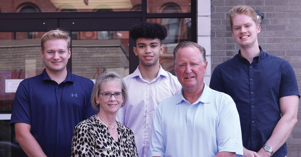 Merchants senior leadership Kelly Julius and Charles Makey with three of Merchants' summer interns standing on the steps of the corporate headquarters