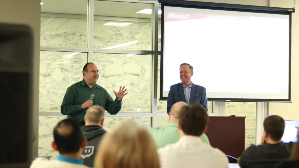 Jason Gallo speaks with colleagues after receiving the 2023 President's Award