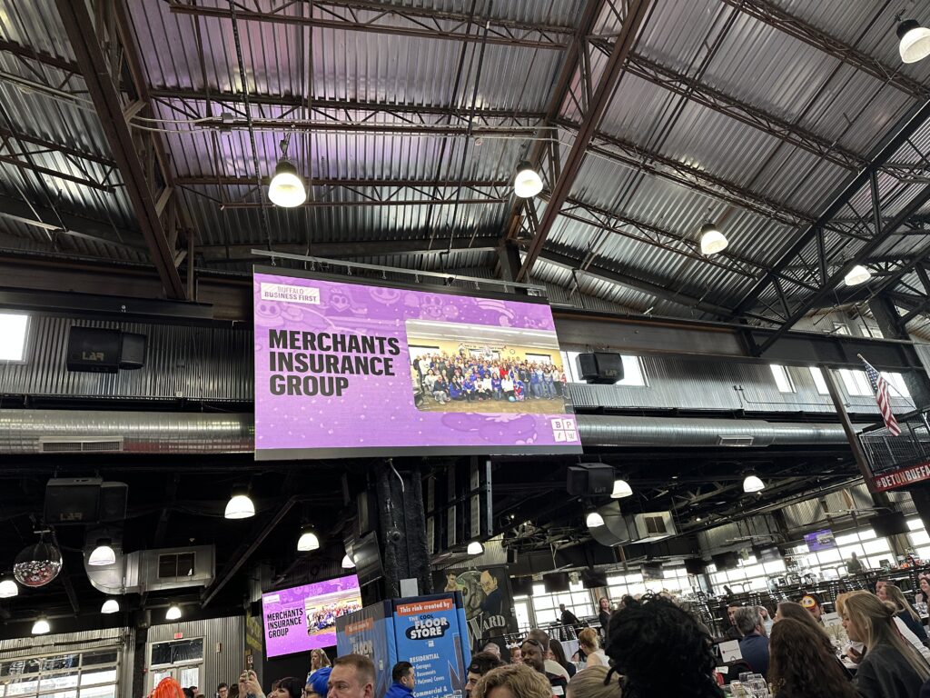 Merchants Insurance Group company name on screen at Best Places to Work event