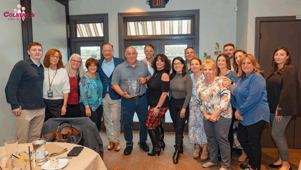 Group photo of Merchants leadership and Colstan & Associates at the Agent of the Year Award Celebration