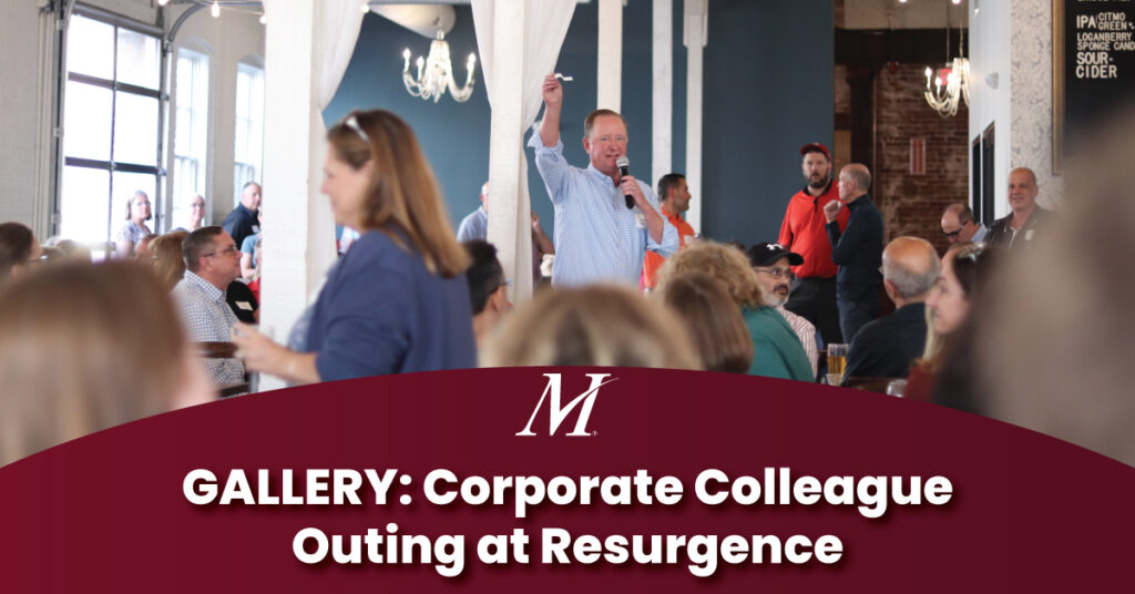 Merchants Insurance Group President and CEO Charles Makey raffles off prizes to corporate colleagues at the annual Colleague Outing at Resurgence in Buffalo, NY. Text reads "GALLERY: Corporate Colleague Outing at Resurgence"