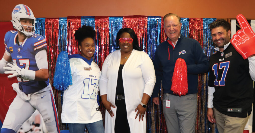 Merchants Bills Bye Week Bash to raise funds for United Way, group photo of United Way representatives and Charlie Makey