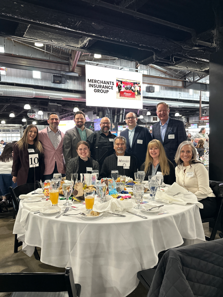 Group photo of Merchants Insurance Group colleagues at Best Places to Work and HR Impact Awards event, 2026
