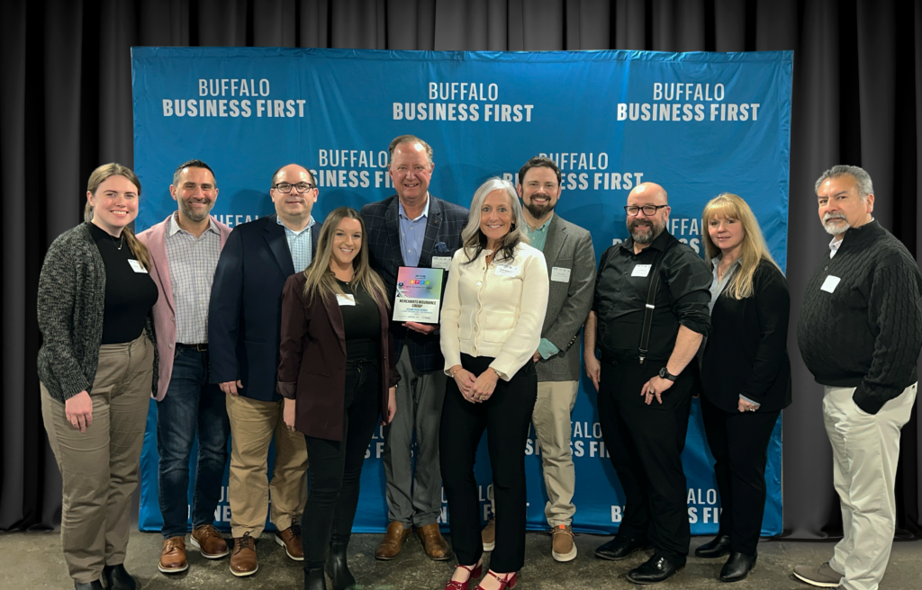 Merchants Insurance Group colleagues at the Buffalo Business First Best Places to Work event, pictured in front of the Buffalo Business First step and repeat backdrop