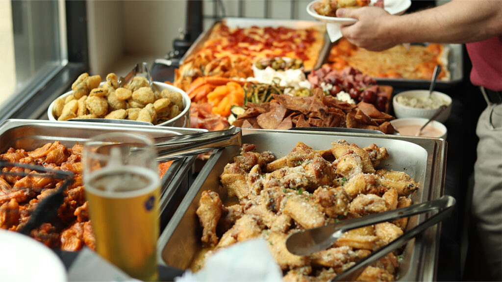 pizza, chicken wings, and appetizers at Merchants' 2026 Colleague Social